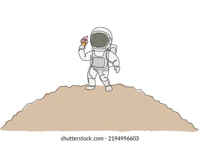 One single line drawing astronaut walking om moon surface while eating sweet cold milk ice cream cone graphic vector illustration. Fantasy outer space life concept. Modern continuous line draw design