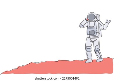 One single line drawing of cosmonaut make a call to partner using smartphone in moon surface vector illustration. Astronaut business office with outer space concept. Modern continuous line draw design