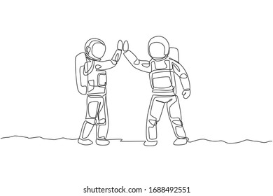 One single line drawing of two young happy astronauts gave high five while meeting on the street in moon surface vector illustration. Cosmonaut outer space concept. Modern continuous line draw design