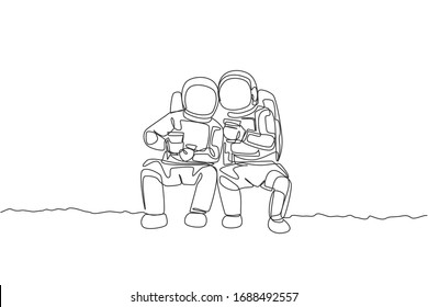 One single line drawing two young happy astronauts sitting while drinking coffee together in moon surface graphic vector illustration. Cosmonaut outer space concept. Modern continuous line draw design