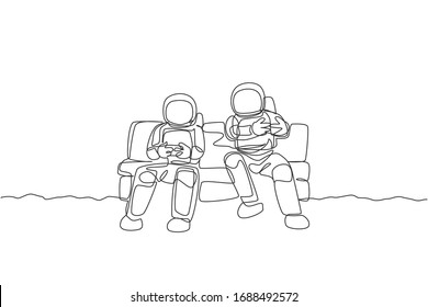 One single line drawing two young happy astronauts siting on sofa and playing video game in moon surface graphic vector illustration. Cosmonaut outer space concept. Modern continuous line draw design
