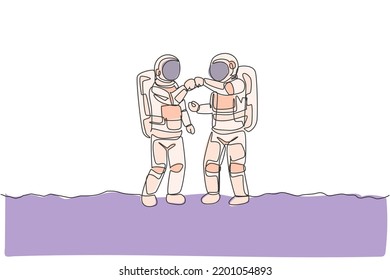 One single line drawing of two young astronauts giving fist bump to celebrate success teamwork in moon surface vector illustration. Cosmonaut outer space concept. Modern continuous line draw design