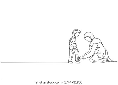 One single line drawing young Islamic mom help her son to tie shoelace before go to the school vector illustration  Happy Arabian muslim family parenting concept  Modern continuous line draw design