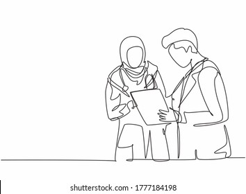 One single line drawing of young male doctor discussing with female Arabic doctor while standing at the hospital hallway. Medical health care concept continuous line draw design vector illustration