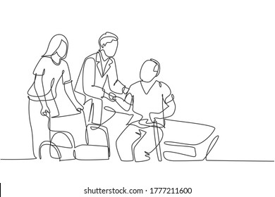 One single line drawing young male doctor helping old patient get to wheelchair from hospital bed  Trendy medical health care service concept continuous line draw design vector graphic illustration