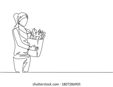 One single line drawing young happy woman holding grocery paper bag with fruits, vegetables, bread, milk inside. Commercial retail shopping concept. Continuous line draw design illustration