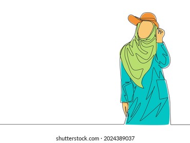 One single line drawing of young happy beauty muslimah wearing cute hat and pose nicely. Beautiful Asian woman model in trendy hijab fashion concept continuous line draw design vector illustration