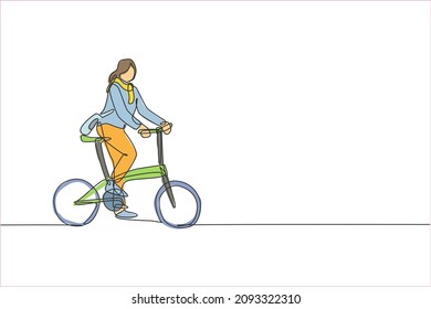 One single line drawing young happy startup employee woman ride bicycle to the coworking space vector illustration graphic. Healthy commuter urban lifestyle concept. Modern continuous line draw design