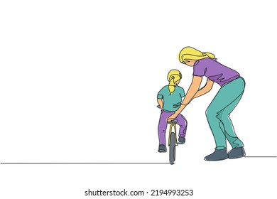One single line drawing young mother teaching her daughter riding bicycle at public park graphic vector illustration. Motherhood lesson. Urban family time concept. Modern continuous line draw design