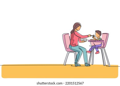 One single line drawing of young mother feeding her son a meal who sit at baby dining chair at home vector graphic illustration. Happy family parenting concept. Modern continuous line draw design