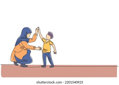 One single line drawing young Arabian mom giving high five gesture to her son boy before go to school vector illustration  Happy Islamic muslim family parenting concept  Continuous line draw design