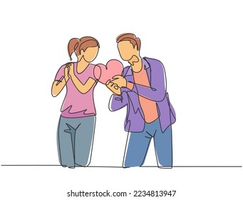One single line drawing of young happy man propose pretty woman with heart shape gift at outside park. Romantic marriage propose concept continuous line draw graphic design vector illustration