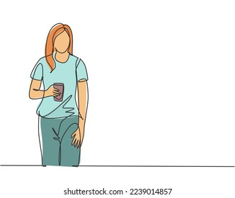 One single line drawing of young female college student standing wearing casual shirt holding a paper cup of coffee drink. Drinking tea concept continuous line draw vector graphic design illustration