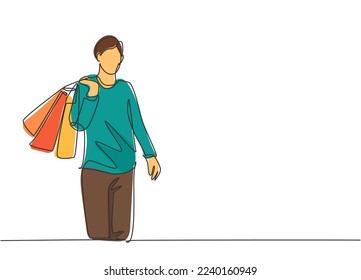 Una sola línea dibujando a un joven alegre hombre atractivo sosteniendo bolsas de papel después de comprar moda y necesidades personales en un centro comercial. Concepto de compras comerciales al por menor. Ilustración de dibujo de línea continua
