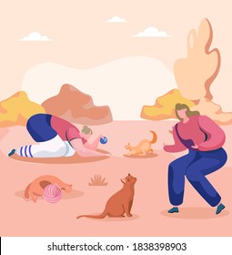 One young woman is playing with the red cat and taming it, while other is using ball of thread to play with a kitten. A cat without an owner lies near a ball of thread. Walk with pets in the park