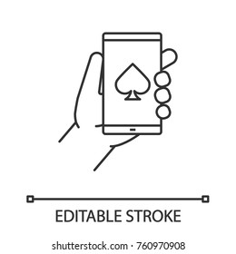 Online casino linear icon. Thin line illustration. Hand holding smartphone with spade card suit sign. Contour symbol. Vector isolated outline drawing. Editable stroke
