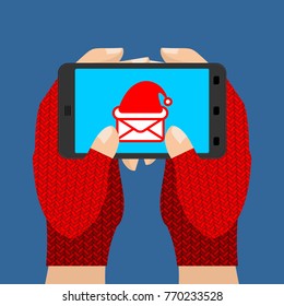 Online ordering of Christmas presents. Hands in mittens hold phone. Winter gloves and gadget. Vector illustration