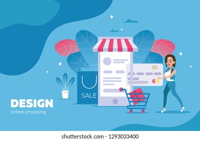 Online purchases and payment by credit card with a young girl, next to the cart of an online store on a large mobile phone