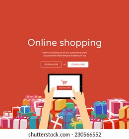 Online shopping with christmas gifts around - man hands holding tablet with add to cart button, flat design illustration