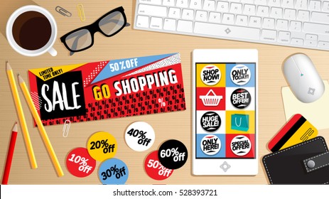 Online shopping concept buy now desktop. Phone on table, keyboard, mouse, pencil, coffee, glasses, credit card, banners, coupons and calculations.