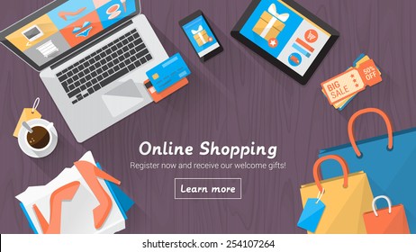 Online shopping concept desktop with computer, table, shopping bags, credit cards, coupons and products