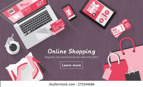 Online shopping concept desktop with computer, table, shopping bags, credit cards, coupons and products