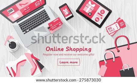 Online shopping concept desktop with computer, table, shopping bags, credit cards, coupons and products