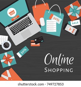 Online shopping concept. Online store objects and banner. Table with laptop, shopping bags, credit cards, gifts and coupons. Flat style, vector illustration.