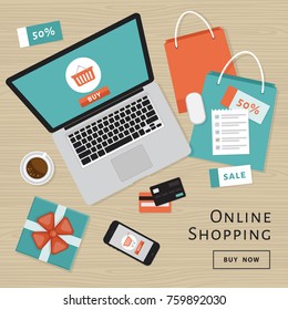 Online shopping concept. Online store objects and banner. Table with laptop, shopping bags, credit cards, gifts and coupons. Flat style, vector illustration.