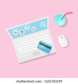 Online shopping with laptop and juice on  pink background