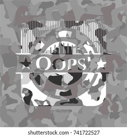 Oops! written on a grey camouflage texture