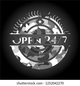 Open 24/7 written on a grey camouflage texture