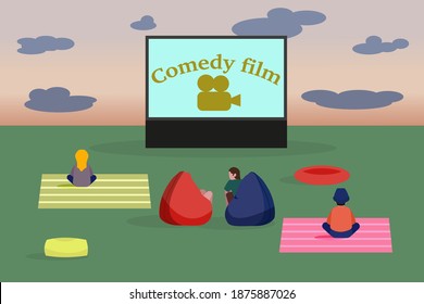 Open air cinema. People watching a movie in the clearing.