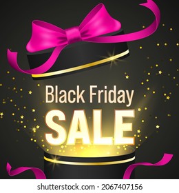 Open black gift box with pink satin ribbon to celebrate Black Friday shopping festival.