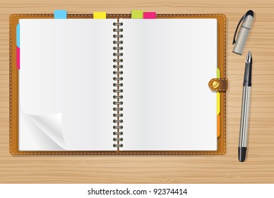 open diary and a pen on office table