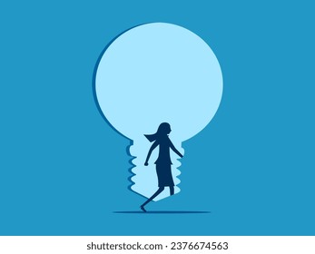 Open the door of knowledge. Businesswoman steps into the light bulb door 