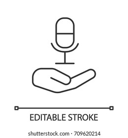 Open hand with microphone linear icon. Thin line illustration. Recording studio. Radio contour symbol. Vector isolated outline drawing. Editable stroke