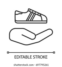 Open hand with sneaker linear icon. Thin line illustration. Shoes store. Contour symbol. Vector isolated outline drawing. Editable stroke