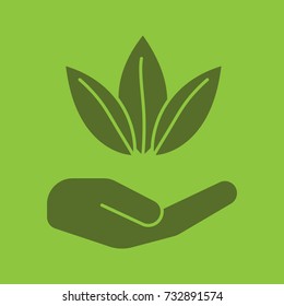 Open hand with tea leaves glyph color icon. Advertising. Silhouette symbol. Tea harvesting and processing. Negative space. Vector isolated illustration