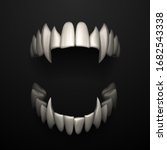 Open jaws with big fangs on black background