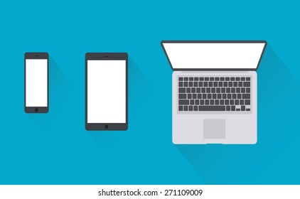 Open laptop with digital tablet and white smartphone