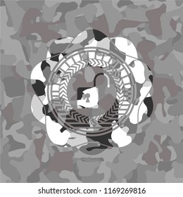 open lock icon inside grey camouflage emblem