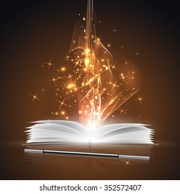 Open magic book and a wand with bright lights.
