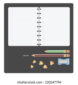 open notebook with pencils, sharpener and pencil shavings