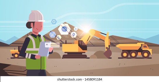 Open Pit Woman Worker In Helmet Using Mobile App Excavator Loading Soil On Dump Truck Professional Equipment Working On Coal Mine Production Opencast Stone Quarry Background Portrait Horizontal