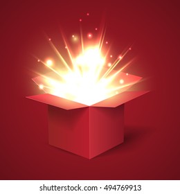 Open red gift box with abstract light. Merry Christmas and Happy New Year. Christmas Holiday.