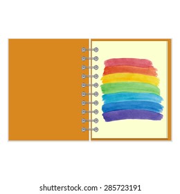 Open ring-bound notebook with painted water color rainbow