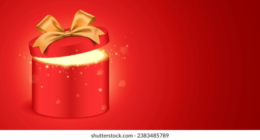 Open round red gift box with a golden ribbon and magical glitter light, shining from inside. Shiny present box standing on red gradient background, with copy space. Holiday gift vector banner design.