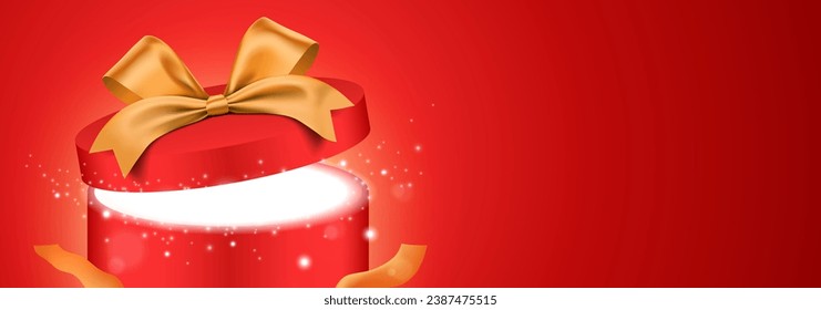 Open round red gift box with golden ribbon and glitter light shining from inside. Shiny present box closeup view on the red gradient background, with copy space. Holiday gift vector banner design.