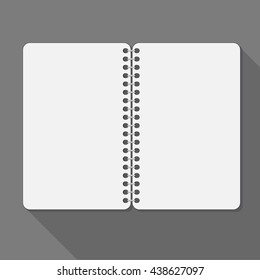 Open spiral notebook. Blank pages and shadow.